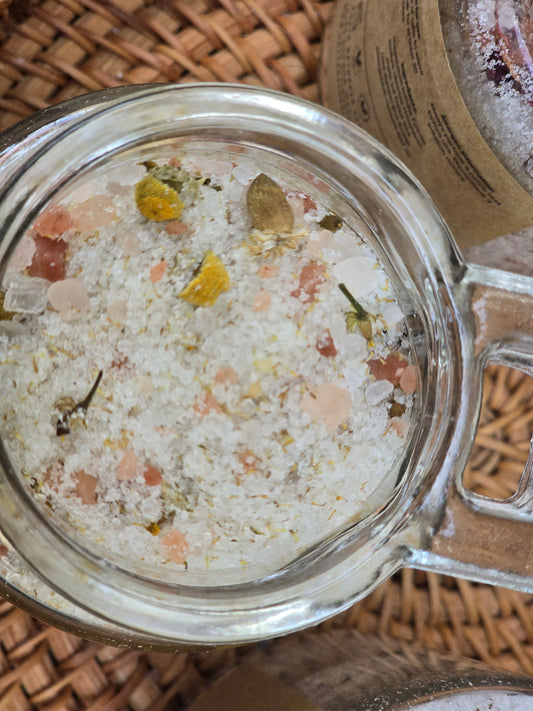 Glass jar filled with bath salts on a woven surface